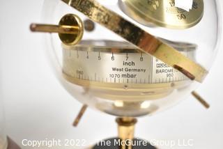 Pair of table display items: clock under glass dome and Barometer/Humidity gauges in a globe