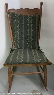 Pressed back oak rocking chair with upholstered cushions (36T at back)