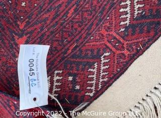 76 x 112" Turkmen Hand Knotted Rug from Afghanistan with Geometric Pattern on Red Ground.  Some moth ball odor.  