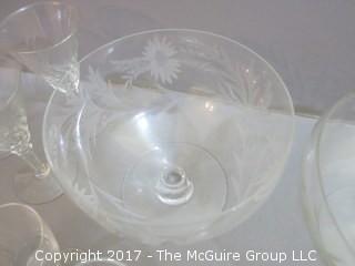 Collection including 2 etched glass serving bowls, a hand blown glass pitcher and splatter glass vase