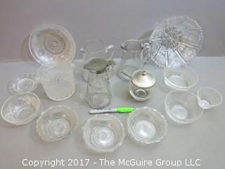 Eclectic collection of vintage glassware including syrup pitchers 