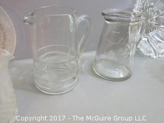 Eclectic collection of vintage glassware including syrup pitchers 