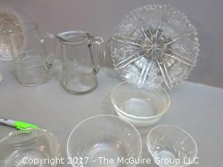 Eclectic collection of vintage glassware including syrup pitchers 