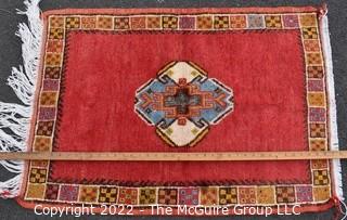 Hand Knotted Persian Wool Rug with Medallion on Orange Ground.  27" x 45".