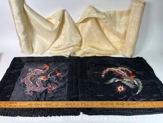 Two (2) Black Asian Silk Embroidered Pillow Cases and Two (2) Bolts of Cream Silk Damask Fabric, One with Ornate Embroiderery and Tax Stamp