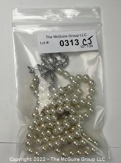 Double Strand Opera Length Faux Pearl with Rhinestone Bow Necklace. 