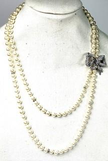 Double Strand Opera Length Faux Pearl with Rhinestone Bow Necklace. 