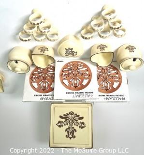 Group of Vintage Pfaltzgraff Village Table Ware Items Including Trivet (New in Box), Sugar or Jam Jar, Napkin Rings, and Hear Jars. 