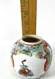 Chinese Hand Painted on White Ground Round Porcelain Vase. Measures 4" tall.