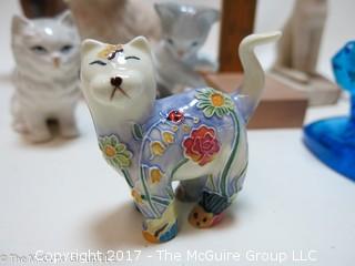 Collection of cat figurines in various media