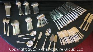 Durgin (later Gorham) Sterling cutlery and chest: 18 dinner forks; 18 knives; 18 meat forks; 18 grapefruit spoons; 18 soup spoons; 22 tea spoons, 2 large serving spoons; 6 medium size serving spoons, 11 small serving spoons, 1 ladle, 17 butter knives and 7 accessory pieces; hallmark shown in photos.  Total weight sterling (excludes dinner knives): 3126 grams  