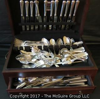 Durgin (later Gorham) Sterling cutlery and chest: 18 dinner forks; 18 knives; 18 meat forks; 18 grapefruit spoons; 18 soup spoons; 22 tea spoons, 2 large serving spoons; 6 medium size serving spoons, 11 small serving spoons, 1 ladle, 17 butter knives and 7 accessory pieces; hallmark shown in photos.  Total weight sterling (excludes dinner knives): 3126 grams  