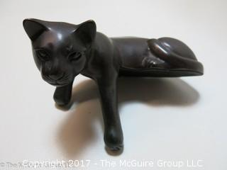 Feline sculpture formed to sit on ledge