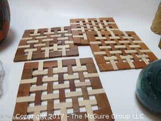 Collection including Irish Kerry Glass, stacked ceramic pigs, and wooden trivets