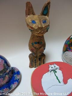 Assortment of feline figurines in various media