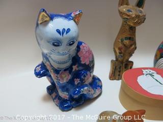 Assortment of feline figurines in various media