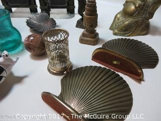 Collection including scalloped shell brass bookends, brass Buddha, and feline themed collectibles 