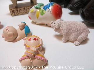 Collection of figurines including mostly pigs 