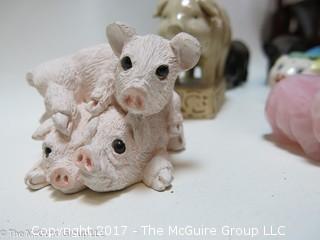 Collection of figurines including mostly pigs 