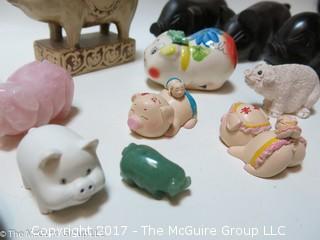 Collection of figurines including mostly pigs 