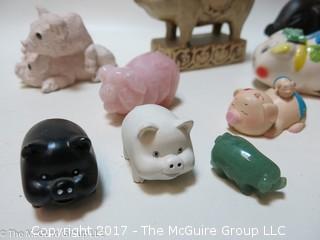 Collection of figurines including mostly pigs 