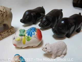 Collection of figurines including mostly pigs 