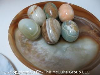 Assorted stone plates, bowls, and eggs 
