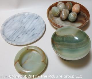 Assorted stone plates, bowls, and eggs 