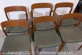 Danish M-C Modern teak dining table and matching chairs (5 side; 1 arm) ; table expands; with leaves stored on the underside, as shown; 45"D x 28 1/2" T