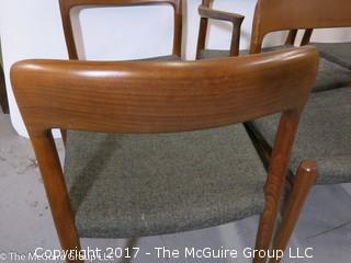 Danish M-C Modern teak dining table and matching chairs (5 side; 1 arm) ; table expands; with leaves stored on the underside, as shown; 45"D x 28 1/2" T