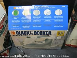 Collection of household appliances including 2 flatirons, hair dryer, knife sharpener, Hoover, Cuisinart chopper and cream whipper 