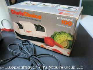 Collection of household appliances including 2 flatirons, hair dryer, knife sharpener, Hoover, Cuisinart chopper and cream whipper 