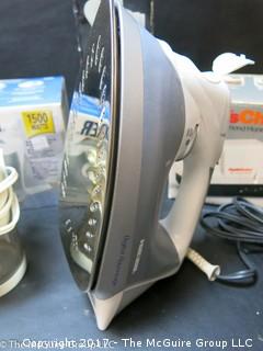 Collection of household appliances including 2 flatirons, hair dryer, knife sharpener, Hoover, Cuisinart chopper and cream whipper 