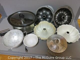 Assorted kitchenware including Crock-POt, Wilton baking molds, collander, paper roll holder and aluminum ice bucket