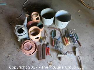 Collection of lawn and garden tools, snow shovels, planters and watering cans 