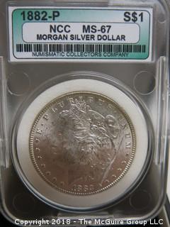 1882 P MORGAN SILVER DOLLAR; SLABBED AND GRADED MS-67 BY NCC 