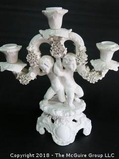 Figural cherub bisque candleabra; made in Italy 