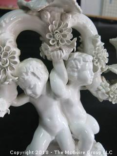 Figural cherub bisque candleabra; made in Italy 