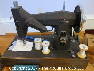 Vintage Kenmore sewing machine with accessories and case