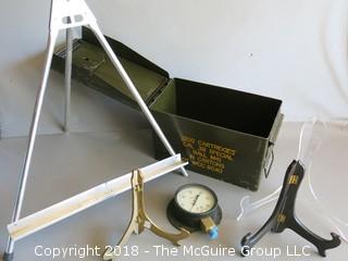 Collection including ammo box, pressure gauge and several plate stands 