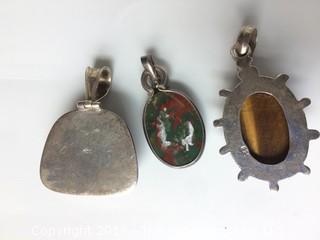 Three Sterling Pendants Set with Tigereye, Red Green Agate, and Lapis Stones