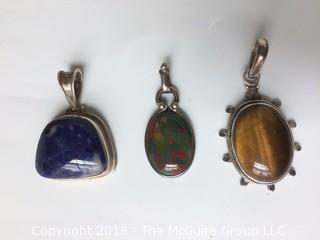 Three Sterling Pendants Set with Tigereye, Red Green Agate, and Lapis Stones