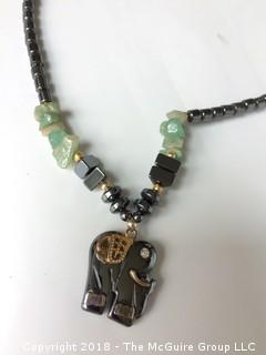 Collection of Five Necklaces Including Agate and Carved Bone Beads, Malachite Elephant, Brass Embedded in Wood Pendant