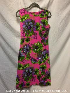 Vintage Women's Sleeveless Floral Dress with Pink Background