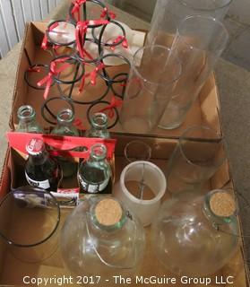 Eclectic collection including coke bottles and glass candle holders  