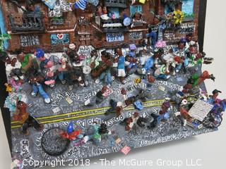 Willie Mays signed montage by Diane Marie Cobert Brunner; depicts street scene in Harlem where Mays was a popular figure participating in local stickball games, where it was said that in the urban game of hitting a rubber ball with an adapted broomstick handle, Mays could hit a shot "six sewers" (6 consecutive New York City manhole covers, nearly 300 feet).  A note card (lower right) says: "In 1950 when the Giants signed me, they gave me $15,000.  I bought a 1950 Mercury.  I couldn't drive, but I had it in the parking lot there, and everybody that could drive would drive the car, so it was like a community "thing" - Willie Mays"  

The artist has exhibited her works at the Empire State Building, the Museum of Contemporary Art in San Diego, the Yogi Berra Museum in New Jersey and the Museum of the Living Artist in San Diego. 21 1/2"W x 26 1/2"T x 7 1/2"D {comes with custom made clear plexiglass cover} Description altered Dec. 6 at 9:54am ET