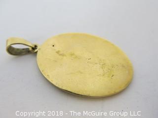 Gold Toned Pendant depicting the god Aesculapius, encircled by a sacred serpent, the symbol of hope and triumph over illness by the veterinary profession. 