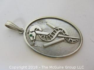 Silver Toned Pendant depicting the god Aesculapius, encircled by a sacred serpent, the symbol of hope and triumph over illness by the veterinary profession. 