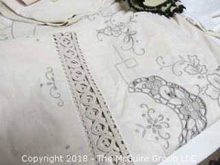 Collection of textiles including needlework tableclothes, napkins, doilies