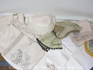 Collection of textiles including needlework tableclothes, napkins, doilies